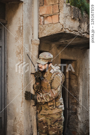 Soldier Communicates With Transceiver Before Entering In A House 126167859