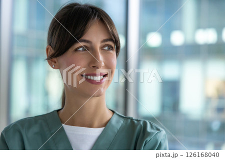 Smiling cute young female doctor looking positive and contented 126168040