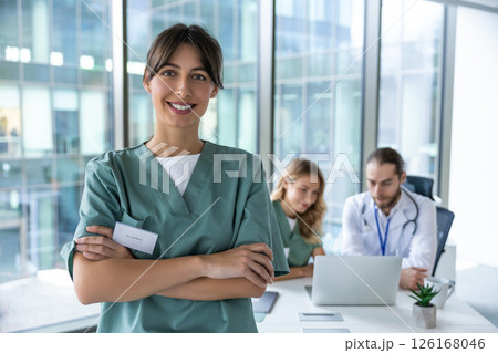 Smiling cute young female doctor looking positive and contented 126168046