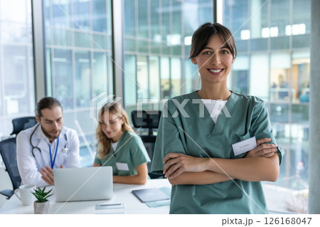 Smiling cute young female doctor looking positive and contented 126168047