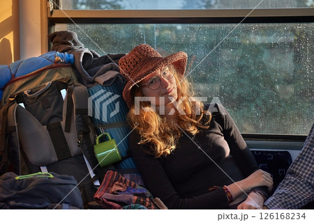 Young woman backpacking trip on a train journey Young woman backpacking trip on a train journey 126168234