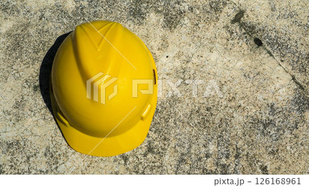 Yellow safety helmet for rough concrete surfaces, urban construction, and industrial workspaces 126168961