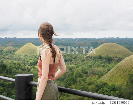 Cute women against the backdrop of Chocolate Hills Cute women against the backdrop of Chocolate Hills 126169065