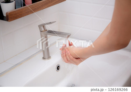 Closeup hands in sink with foaming soap, feeling hygienic and refreshed for prevention virus. 126169266