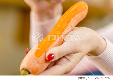 Woman peeling carrot vegetable Woman peeling carrot vegetable 126169360
