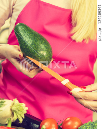 Woman cutting avocado Woman cutting avocado 126169361