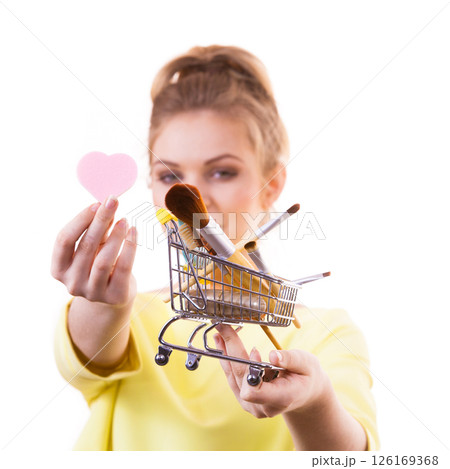 Woman holding shopping cart with make up brushes 126169368