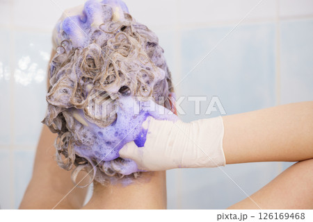 Woman under the shower with colored foam on hair 126169468
