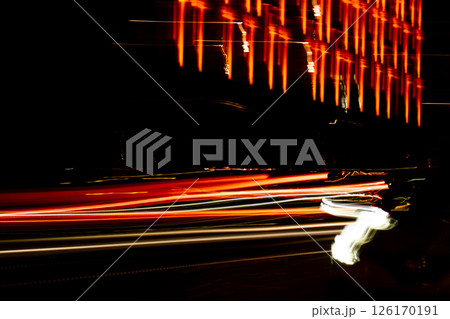 Lights of cars at night. Street line lights. Night highway city. Long exposure photograph night road. Colored bands of red light trails on the road. Background wallpaper defocused  126170191