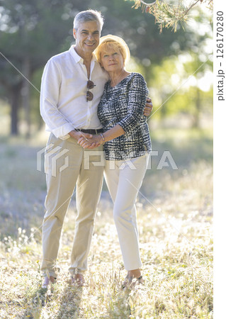 Happy senior couple holding hands and embracing in nature 126170280