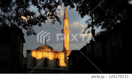 Golden Hour Sunset View of Mosque Minaret and Dome Urban Architecture Cityscape 126170515