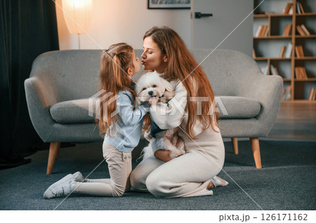 On the floor with pet together. Mother with daughter is at home with maltese dog 126171162