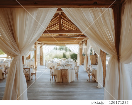 Rustic wooden tent wedding with white curtains, elegant tables, and romantic outdoor setting. Rustic wooden tent wedding with white curtains, elegant tables, and romantic outdoor setting. 126171285