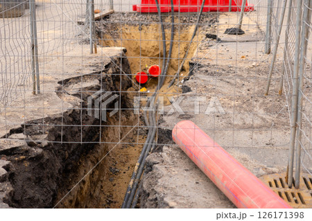 Repair of sewage heating systems or electricity. A trench has been dug in the ground. Repair of sewage heating systems or electricity. A trench has been dug in the ground. 126171398