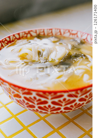 plate of noodles and chopsticks. vegetable ramen in a bright blue plate. Asian dishes. 126171400