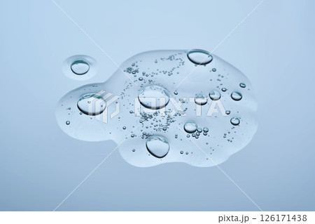A swatch of hyaluronic serum on a blue background. A swatch of hyaluronic serum on a blue background. 126171438