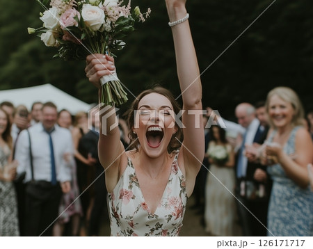 The bridesmaids catching the bride's bouquet is a joyful moment during the wedding celebration. 126171717