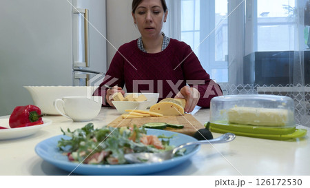 Woman eating borscht on served wooden table 126172530