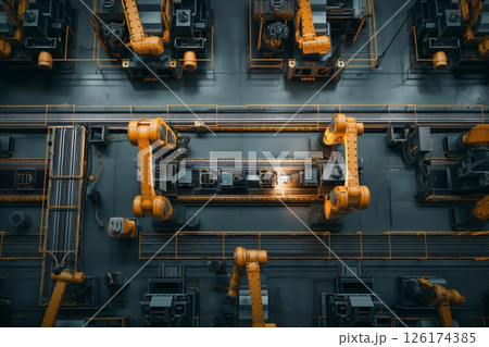 Top down view of a modern factory with robotic arms assembling a product on a production line 126174385