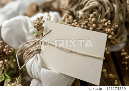 Heartfelt note on a stylish greeting card surrounded by delicate flowers and soft fabrics creates a warm, thoughtful gesture 126175230