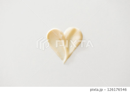 Hair conditioner heart shape. Beige shampoo texture or skincare beauty product smear Hair conditioner heart shape. Beige shampoo texture or skincare beauty product smear 126176546