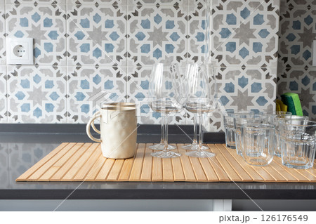 Kitchen counter with washed glassware and ceramic mug 126176549