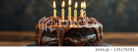 Delicious chocolate cake adorned with candles, perfect for celebration moments and birthday festivities in a cozy kitchen setting Delicious chocolate cake adorned with candles, perfect for celebration moments and birthday festivities in a cozy kitchen setting 126176591