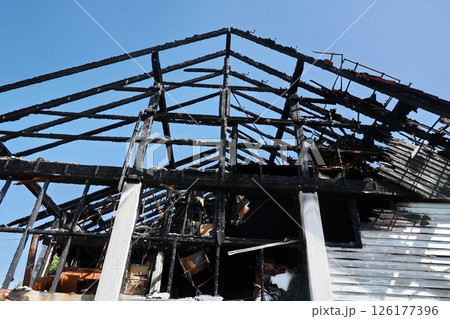A building with a black roof and a black interior A building with a black roof and a black interior 126177396