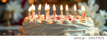 Celebrating a birthday with a beautifully decorated cake featuring lit candles and festive decorations 126177671