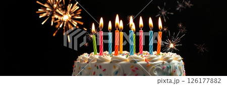 Colorful birthday cake with candles and fireworks creates a joyful celebration atmosphere 126177882