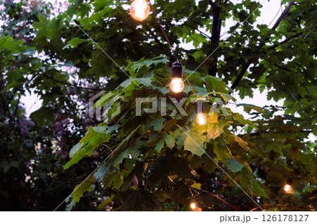 Interior of the cafe. interior Street cafe. Cozy street with garland and French-style cafe. Decor facade of coffee house. 126178127
