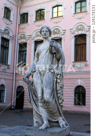 Greek classical ancient statue. Old roof statue of a Renaissance Era woman philosopher and poet. Greek classical ancient statue. Old roof statue of a Renaissance Era woman philosopher and poet. 126178131