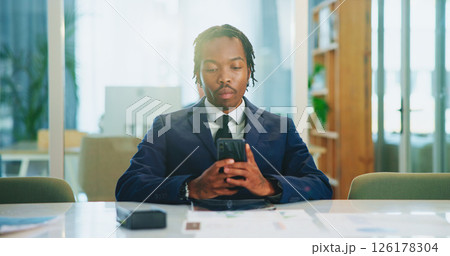 Phone, business and serious black man in office to check email, message or investment banking. Mobile, worker and reading report online for financial news, economy or update on internet with chat app Phone, business and serious black man in office to check email, message or investment banking. Mobile, worker and reading report online for financial news, economy or update on internet with chat app 126178304