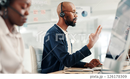Man, agent or discussion with headset at call center for customer service or online advice. Male person, consultant or employee talking with mic on technology for virtual assistance or help at office Man, agent or discussion with headset at call center for customer service or online advice. Male person, consultant or employee talking with mic on technology for virtual assistance or help at office 126178309