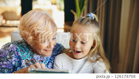 Bonding, family or tablet with grandmother and grandchild on sofa in living room of retirement home for visit. App, relax or smile with girl and old woman in apartment for weekend conversation 126178708