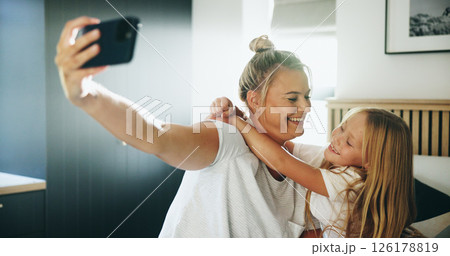 Happy mom, kid and bed with hug or selfie for photography, memory or picture together at home. Mother, child or daughter with smile, love or embrace in bedroom for capture moment or bonding at house 126178819