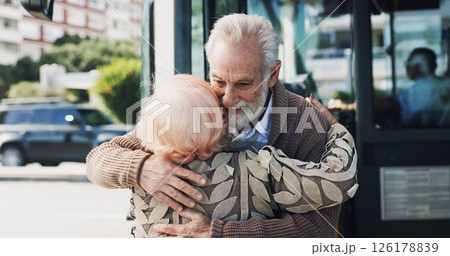 Senior couple, hug and travel in city for greeting, reunion and journey for visit at bus stop. Elderly people, passenger and embrace for commute of public transport, parting gesture and farewell trip 126178839