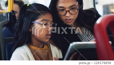 Bus, mother and child with tablet for commute, connection and reading online with conversation for trip. Public transport, mom and girl with technology for streaming app, educational game and travel Bus, mother and child with tablet for commute, connection and reading online with conversation for trip. Public transport, mom and girl with technology for streaming app, educational game and travel 126178856