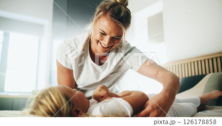 Home, mom and girl with tickle for playing, laughing and bonding together with happy smile. Bedroom, mother and child with funny game for connection, childhood activity and support for trust or relax 126178858