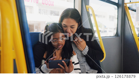 Travel, mom and child with phone, bus and watching movies with tech, passenger and public transport. Journey, woman and bonding with daughter in vehicle, streaming or smile for cartoons on mobile app 126178879