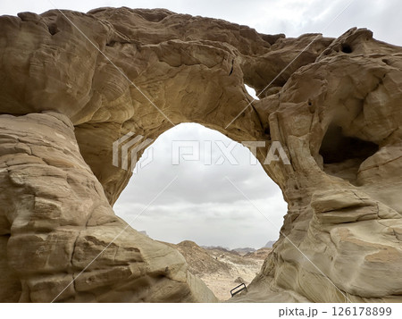 An arch formed by erosion and weathering in Timna Park in the Arava desert 126178899