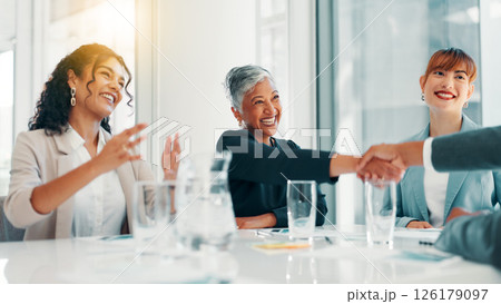 Business people, applause and handshake at office with meeting, profit and goals at finance agency. Group, women and excited with promotion, celebration and achievement with revenue growth at company 126179097