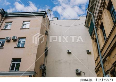 Air conditioning on facade of building and windows in the southern hot country. Air conditioning on facade of building and windows in the southern hot country. 126179974