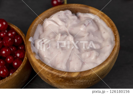 yogurt and currants, a red fermented milk product made from milk with the addition of red sweet and sour currants and currant flavor yogurt and currants, a red fermented milk product made from milk with the addition of red sweet and sour currants and currant flavor 126180156