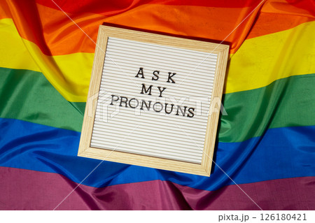 ASK MY PRONOUNS text Neo pronouns concept on Rainbow flag background gender pronouns. Non-binary people rights transgenders. Lgbtq community support assume my gender tolerance equal rights 126180421