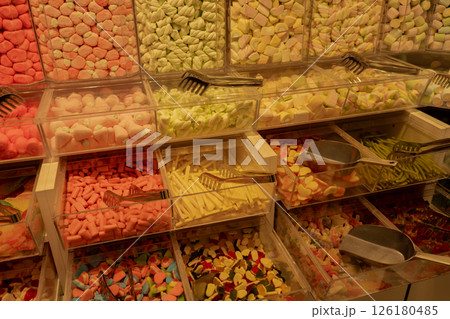 Colorful Candies in Jars. Large choice of sweets in candy shop. Chewy marmalade and small caramels. Assorted gummy candies 126180485