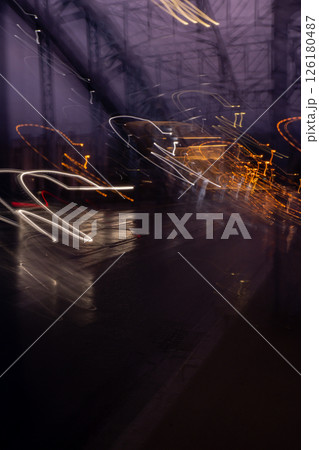 Defocused Lights of cars at night in Krakow bridge. Street line lights. Night highway city. Long exposure photograph night road. Colored bands of red light trails on the road. Background wallpaper  126180487