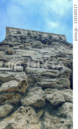 Ancient historical tower from stone bricks low angle view. Ancient historical tower from stone bricks low angle view. 126180517