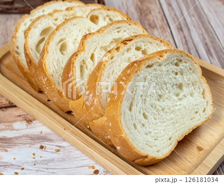 Five Slices of Bread on a Wooden Board 126181034