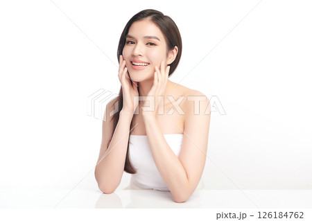 A beautiful young Asian woman with clean, fresh skin against a white background. Skincare, facial treatment, cosmetology, beauty, and spa. An elegant portrait of an Asian woman. 126184762